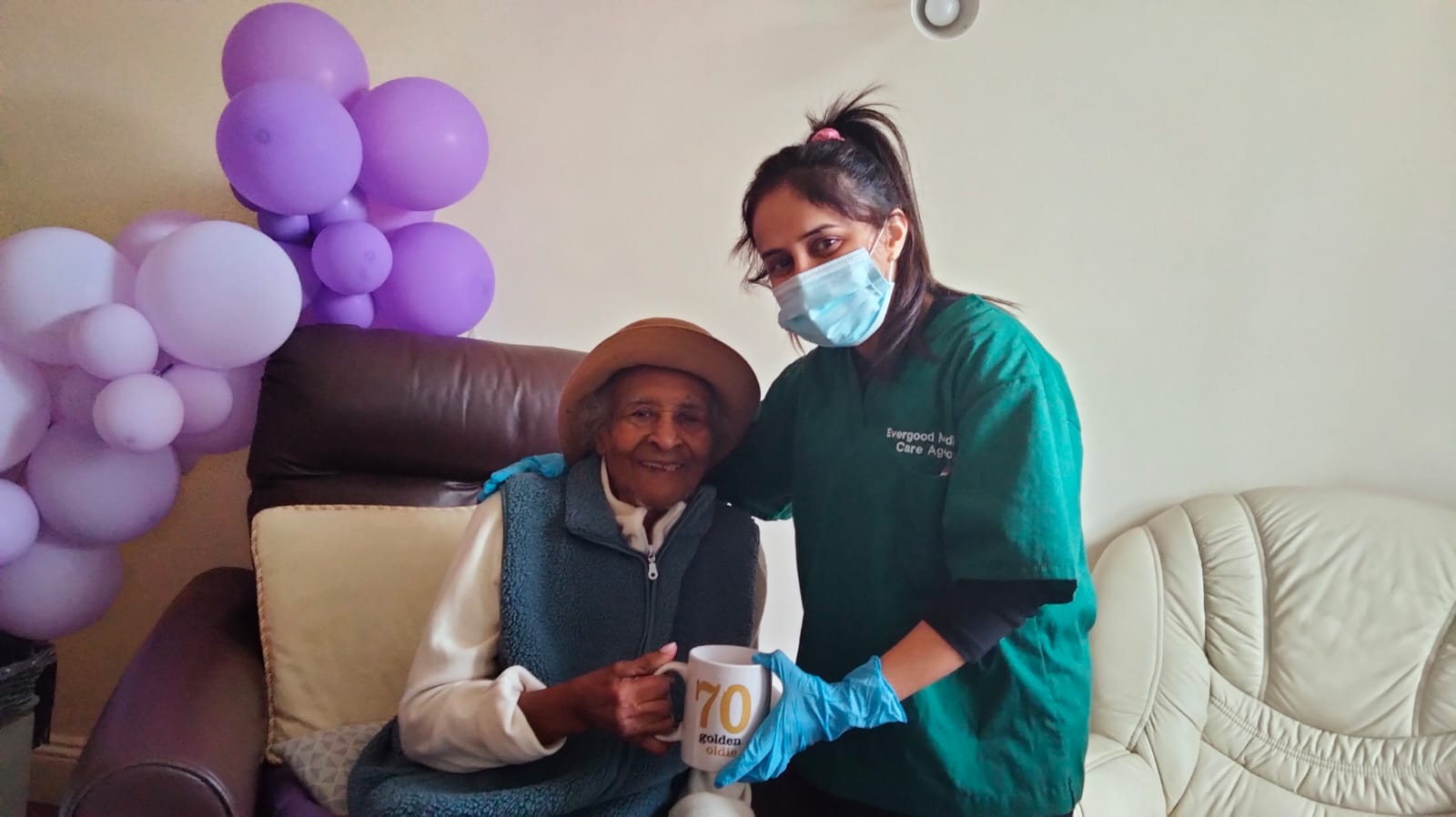 Evergood Medicals carer in teal uniform providing trusted home care in Crawley to an elderly lady at home