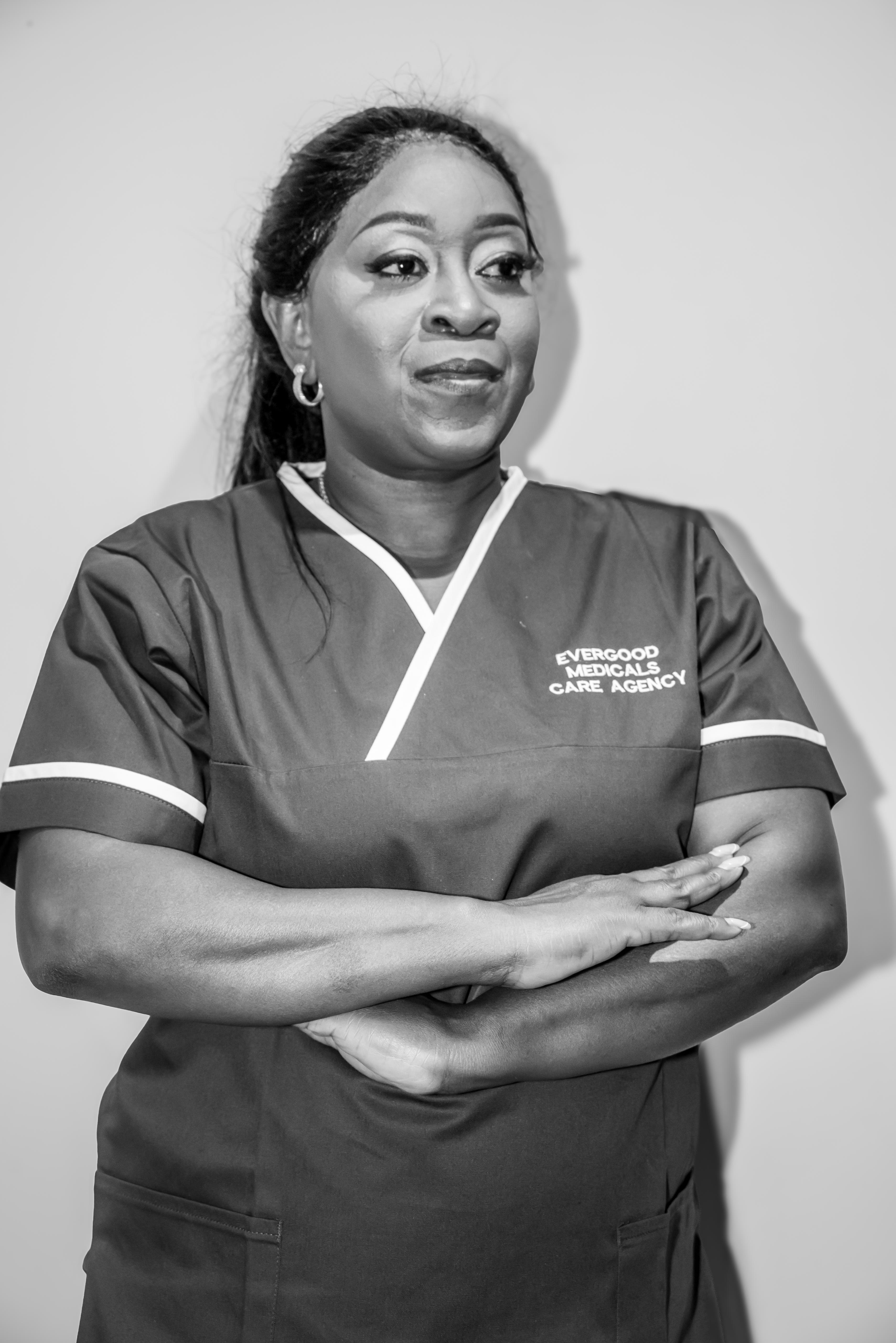 A black and white portrait of an Evergood Medicals carer in uniform